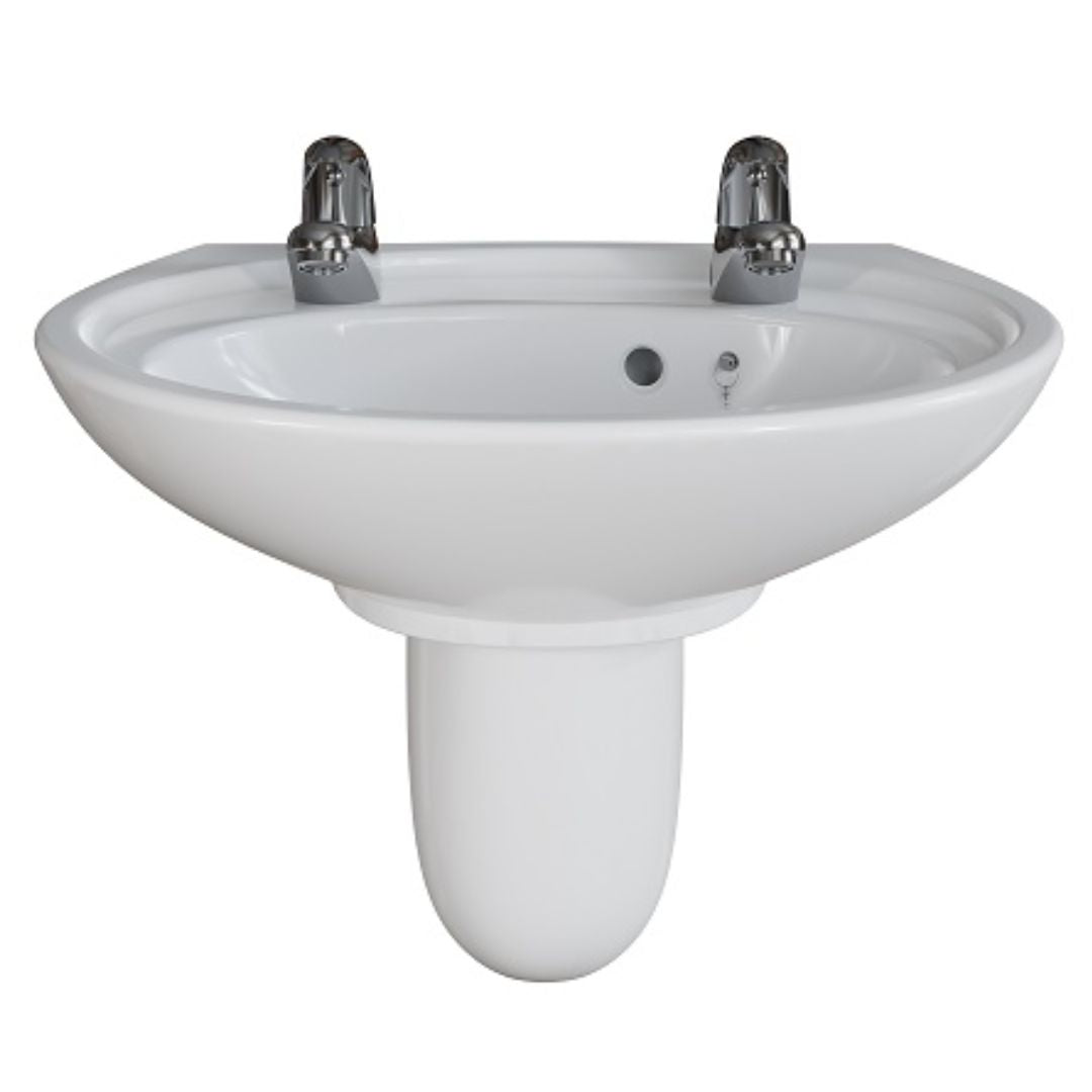 A white ceramic pedestal bathroom sink with two chrome faucets, shown against a plain white background.