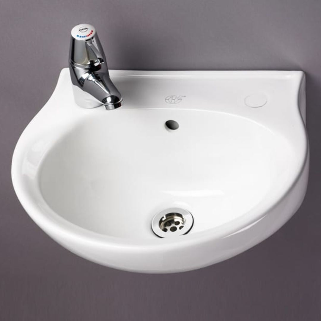 A white ceramic wall-mounted bathroom sink with a chrome faucet, shown against a solid dark grey background.