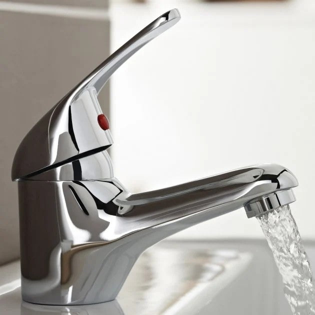 Chrome faucet with water flowing in a bathroom setting