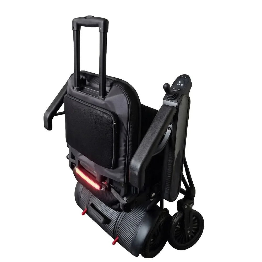 Black electric wheelchair with a telescoping handle, foldable seat, and a red light illuminated on the rear, shown on a plain white background.