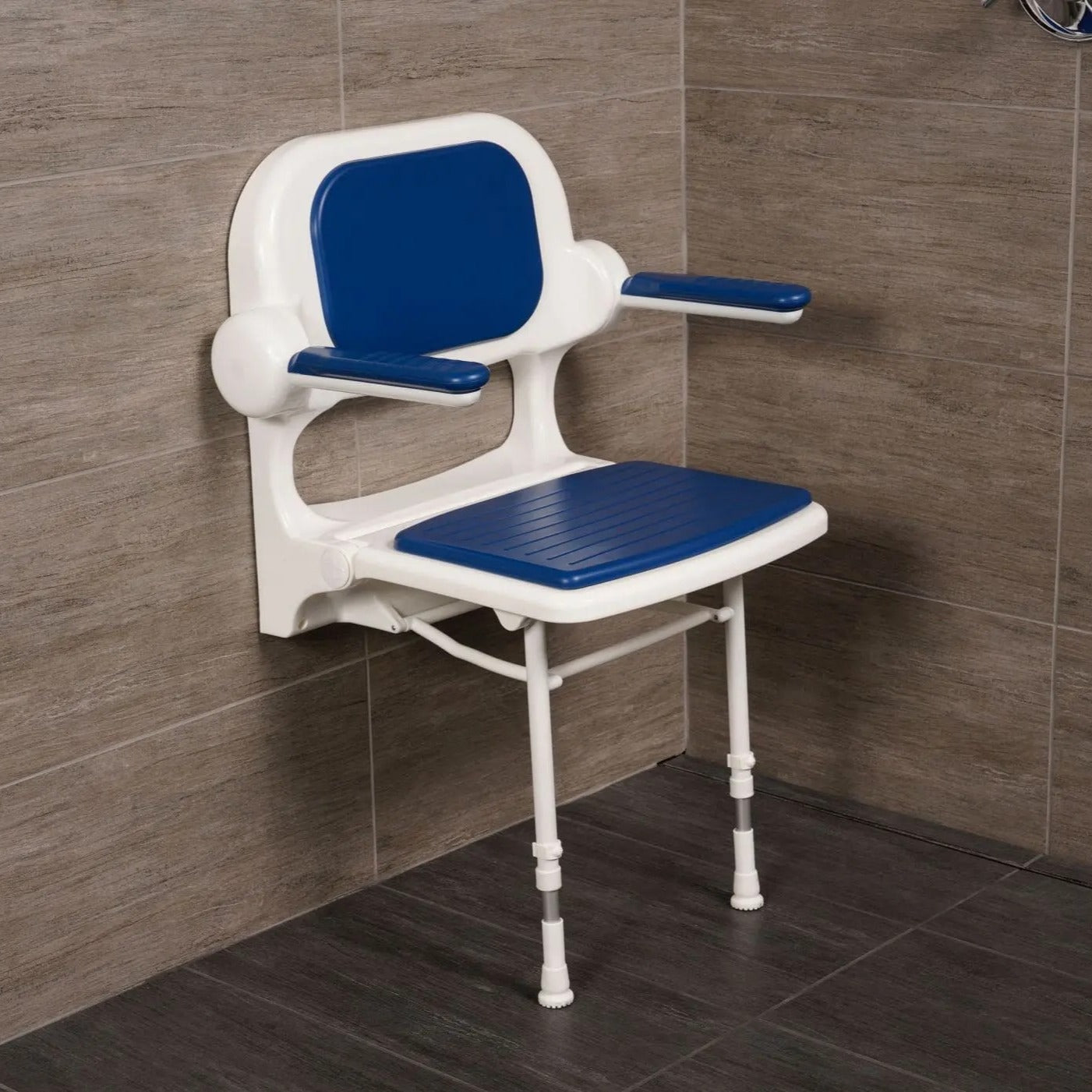 Blue and white shower chair against a tiled bathroom wall.
