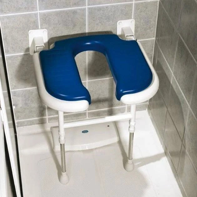 Blue and white adjustable shower seat mounted on a tiled bathroom wall.