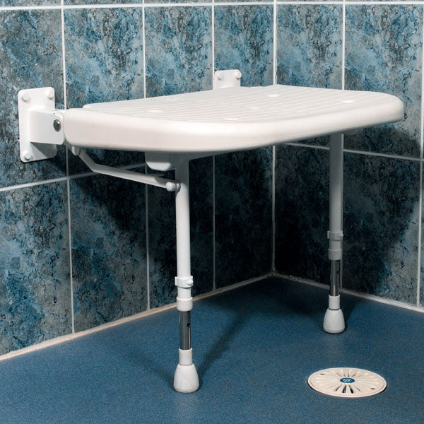 Wall-mounted shower seat in a tiled bathroom