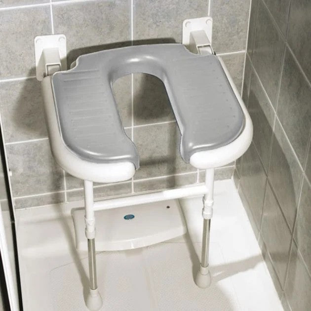 Gray and white adjustable shower seat mounted on a tiled bathroom wall.