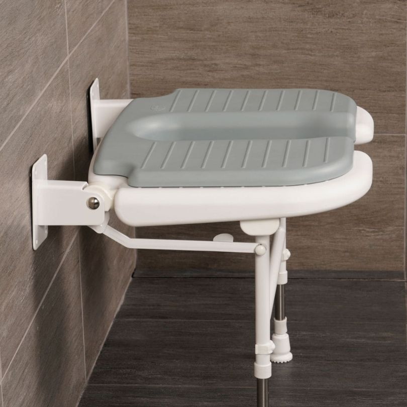 side on view of shower seat in bathroom setting
