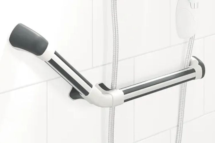 A wall-mounted shower grab bar with a black and white design, shown installed on a white tiled bathroom wall next to a shower hose.