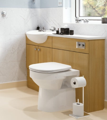 Bathroom with wooden vanity, toilet, and sink.