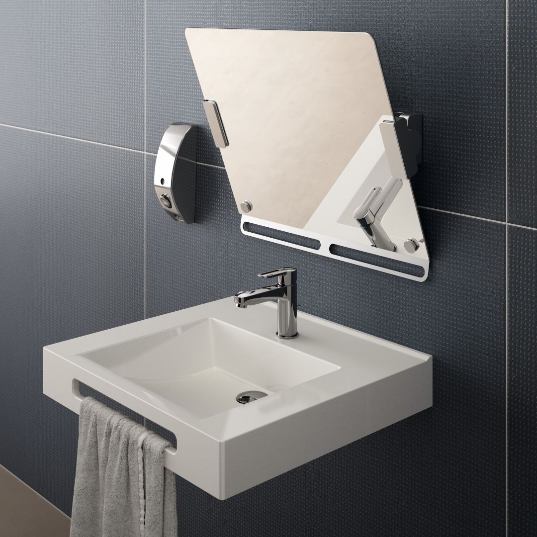 A modern wall-mounted white sink with a chrome faucet, a gray towel hanging from the edge, and an attached rectangular mirror on a dark tiled wall.