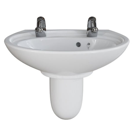 A white ceramic pedestal bathroom sink with two chrome faucets, shown against a plain white background.