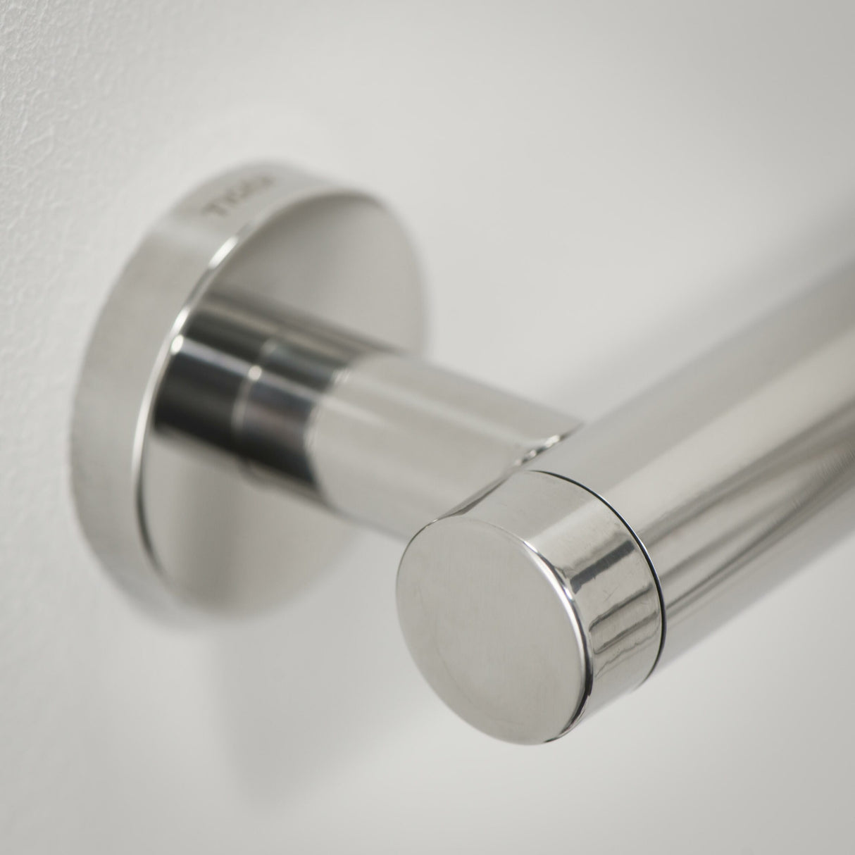 Chrome towel bar on a white wall