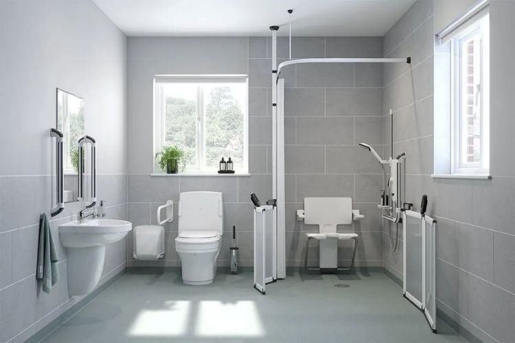 Bathroom with accessibility features including a toilet, sink, and shower facilities.