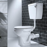 A white ceramic toilet with a wall-mounted cistern and white drainage pipe, set against a black subway tile wall and a white wall.