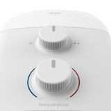 Close-up of a white AKW shower control panel with two rotary dials and temperature markings.