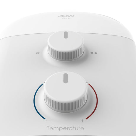 Close-up of a white AKW shower control panel with two rotary dials and temperature markings.