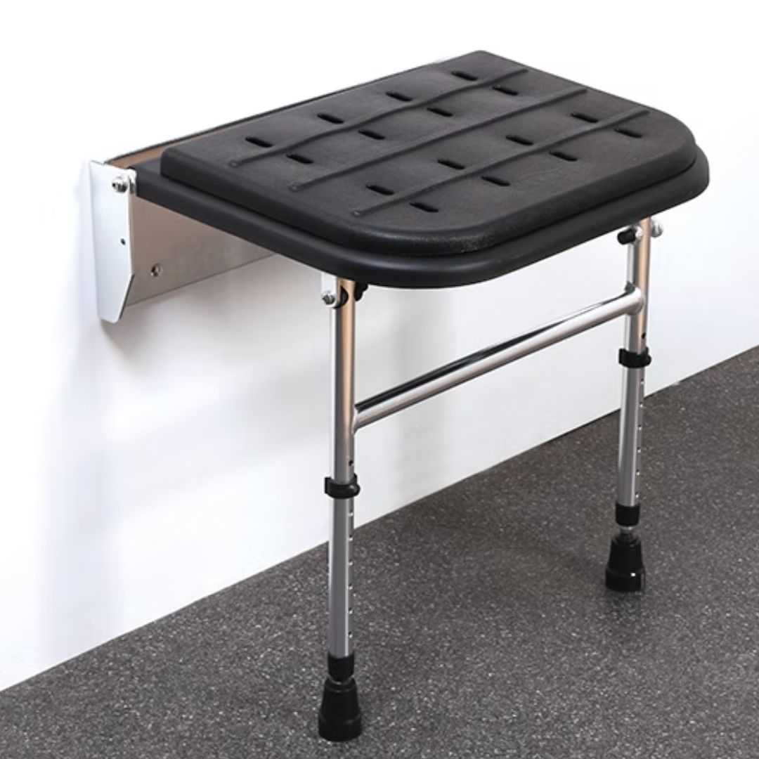 Balck foldable shower seat with  chrome legs against a white wall