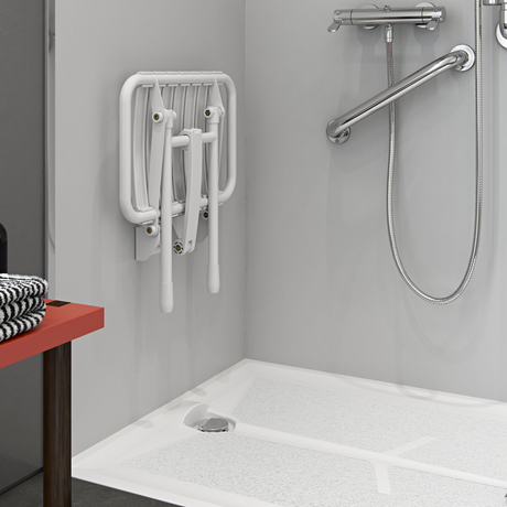 Shower stall with grab bar and seat in a bathroom setting