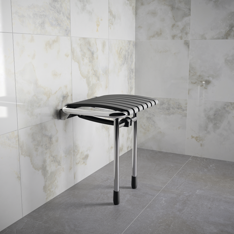 Foldable shower stool against a tiled wall in a bathroom setting