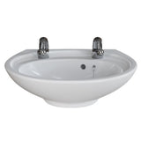 A white ceramic bathroom sink with two polished chrome faucets, shown against a plain white background.