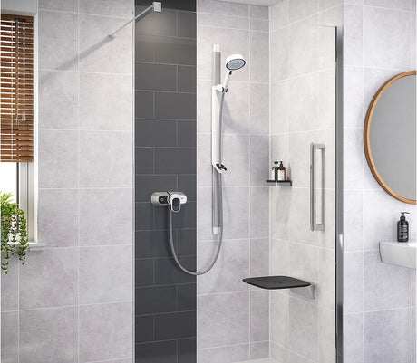 Modern bathroom with shower setup, including a handheld shower head and control panel.