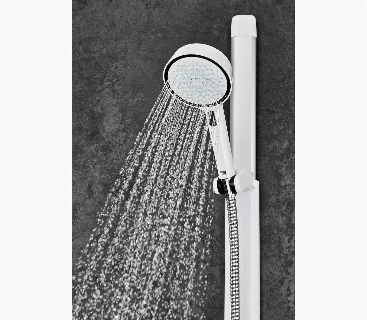 Handheld shower head with water flowing against a dark gray background