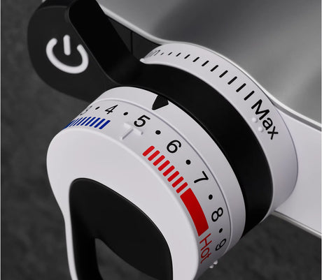 Close-up of a white kitchen timer with black and red markings on a dark background