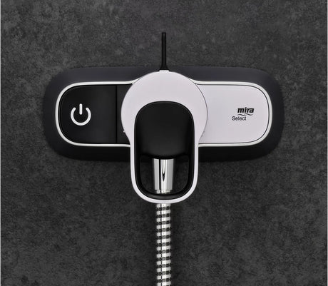 Mira shower head control with power symbol on a dark background