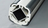 Close-up of a metallic profile with a black square insert on a gray background