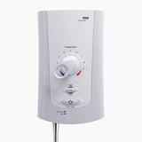 A white Mira electric shower with a central temperature dial, flow and low-pressure protection buttons, and a flexible metal hose at the bottom, shown against a light gray background