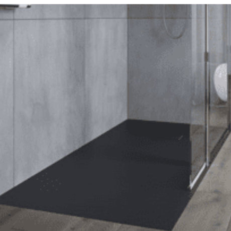 Black shower tray in a shower enclosure with gray walls.