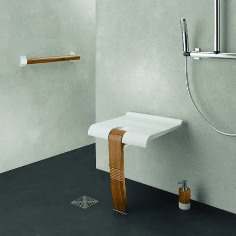 White shower seat with wooden leg, in modern bathroom setting