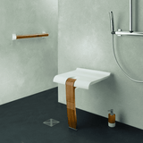 Bathroom setting with a white sink on a wooden stand against a gray wall.