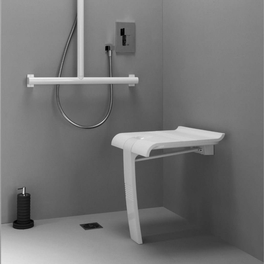 Wall-mounted shower seat in a bathroom setting with gray walls and floor.