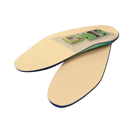 A pair of beige insoles with integrated electronic sensors on a clean white background.