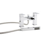 Chrome bathtub faucet with handheld shower head on a white background