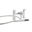 Chrome bath filler and shower attachment on a whilte background 