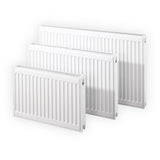 Three white panel radiators of different sizes arranged in a staggered display on a clean white background.