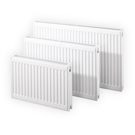 Three white panel radiators of different sizes arranged in a staggered display on a clean white background.