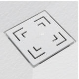A square white textured tile with a recessed geometric maze-like pattern in the corners and a small embossed logo in the center, shown on a matching light gray textured background.