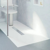 Bathroom setting with a shower tray and wall-mounted shower head.