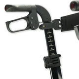 Close-up of a black adjustable rollator handlebar assembly with grip controls and a height adjustment scale marked 2 through 6 MAX, on a white background.