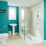 Modern bathroom with teal walls, glass shower enclosure, and white fixtures with shower tray