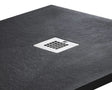 Gray shower tray with a central chrome drain cover on a white background