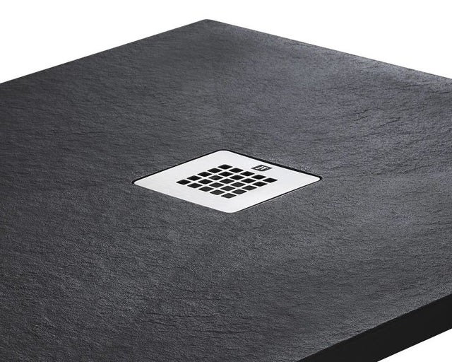 Gray shower tray with a central chrome drain cover on a white background