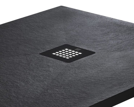 Black rectangular shower tray with a central graphite drain cover on a white background