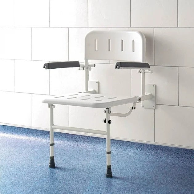 White shower seat with arms and back attached to a wall