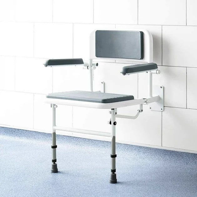 White shower seat with grey padding against a wall